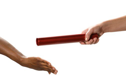 A person holding a red slob showing other person hand